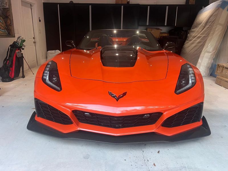 Orange Corvette ZR1 head-on in a garage